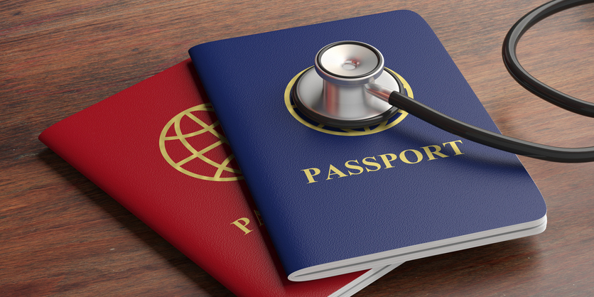Blue and red passports and medical stethoscope on wooden background. 3d illustration